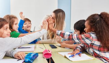 Group,Of,Students,Makes,High,Five,In,The,Classroom,Of