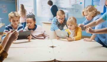 Elementary School Computer Science Class: Children Use Digital Tablet Computers and Smartphones with Augmented Reality Software, They're Excited, Full of Wonder. Children in STEM, Playing and Learning